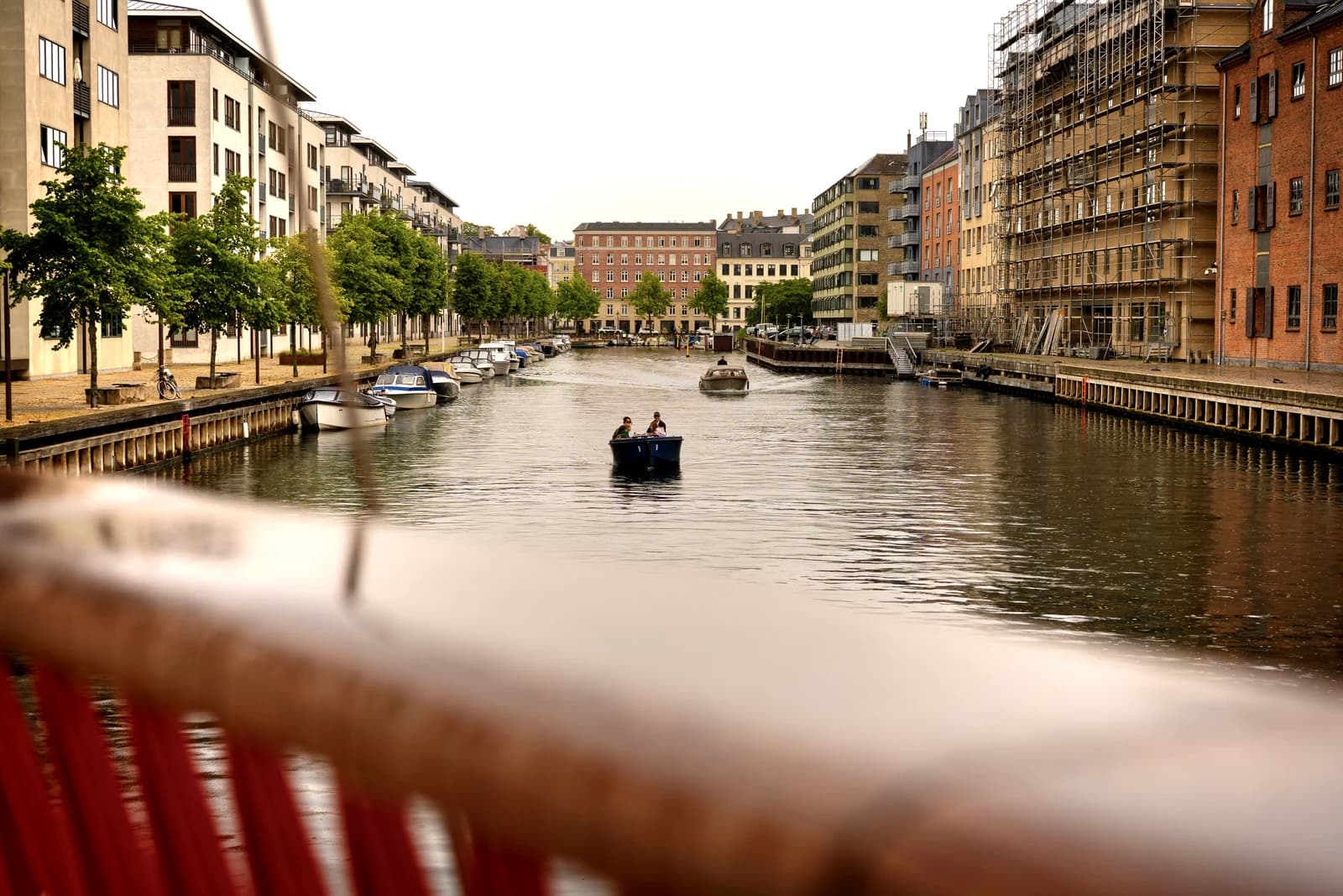 The Christianshavn canal seen from the bridge, with small boats on the water and the rows of houses along the quay.