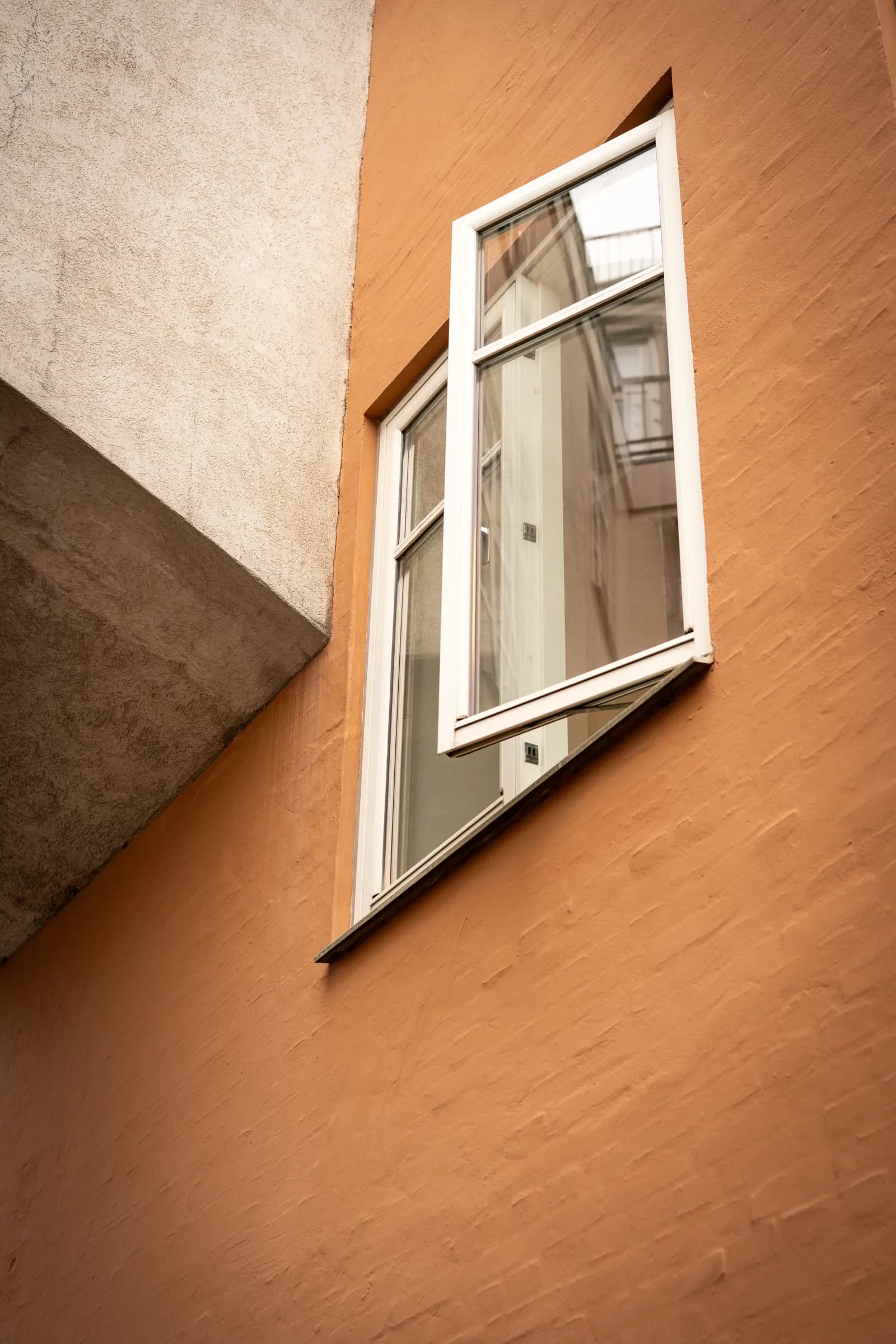 An open window in the ochre wall of the building on Overgaden Neden Vandet.